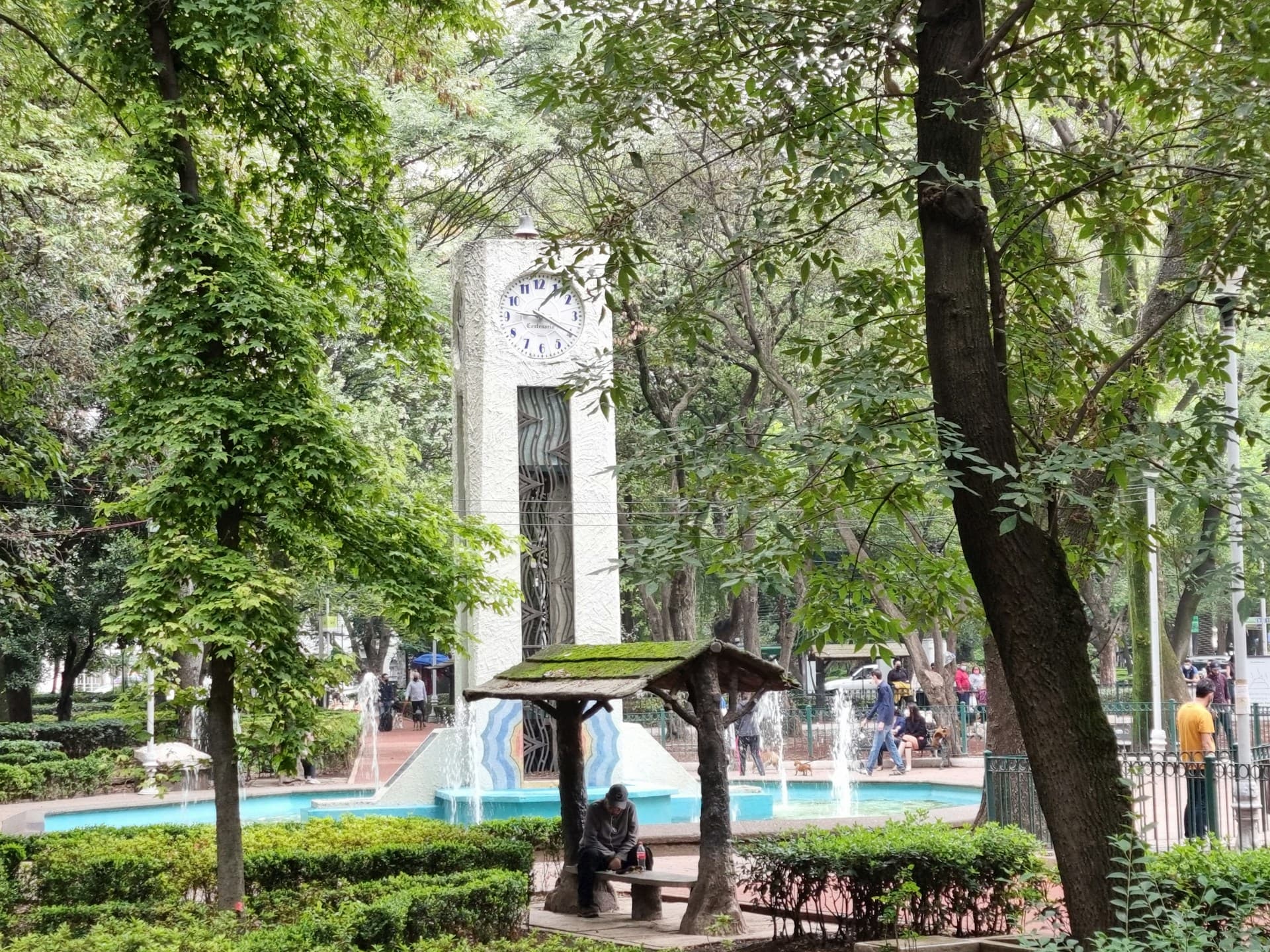 A leafy street in Colonia Roma or Condesa with Art Deco architecture and café tables