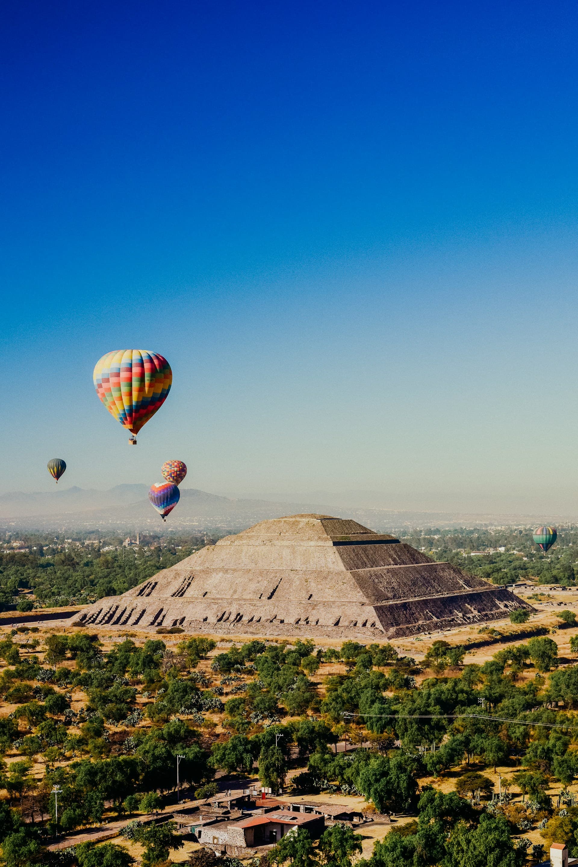 Hot-air balloons at sunrise over the Pyramid of the Sun at Teotihuacán