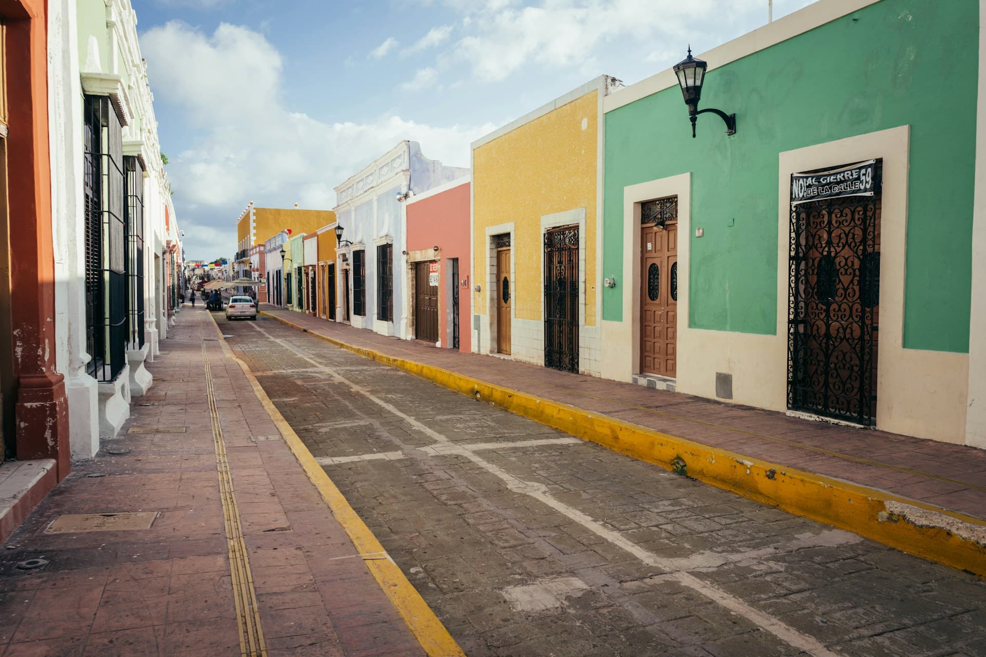 Quinta Avenida in Playa del Carmen at night, with shopfronts and pedestrians