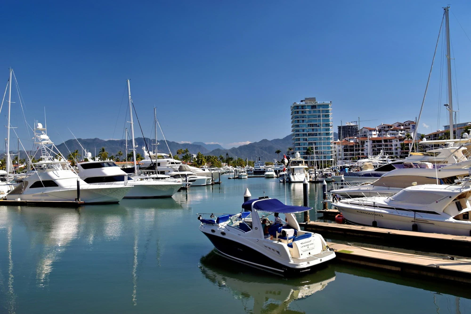 Boats and yachts docked at Marina Vallarta on a sunny day